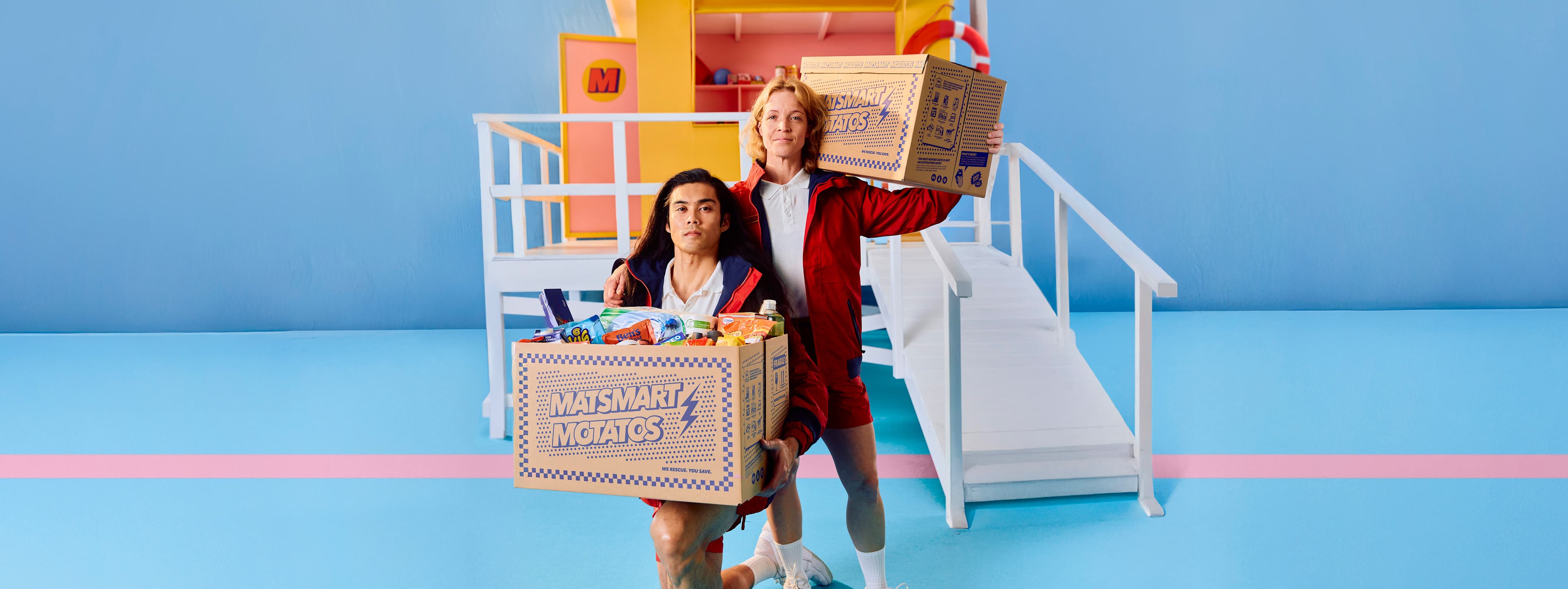 A man and woman holding large carboard boxes labeled 'Matsmart Motatos' 